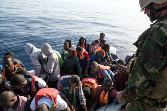 A Libyan coast guardsman watches over during an operation to rescue illegal immigrants who attempted to reach Europe off the coastal town of Zawiyah, 45 kilometres west of the capital Tripoli, on June 27, 2017.