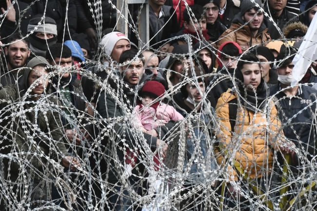 This picture taken from the Greek side of the Greece-Turkey border near Kastanies, shows migrants waiting on the Turkish side on March 2, 2020.