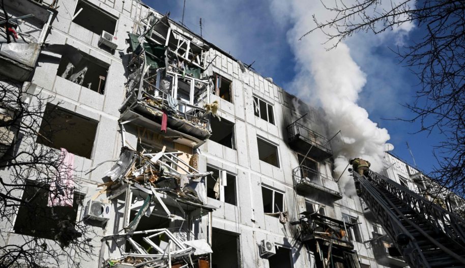 Photo by ARIS MESFirefighters work on a fire on a building after bombings on the eastern Ukraine town of Chuguiv on February 24, 2022, as Russian armed forces are trying to invade Ukraine. SINIS/AFP via Getty Images