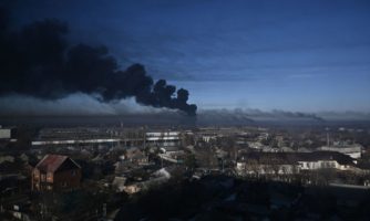 Black smoke rises from a military airport in Chuguyev near Kharkiv on February 24, 2022. Photo by ARIS MESSINIS/AFP via Getty Images