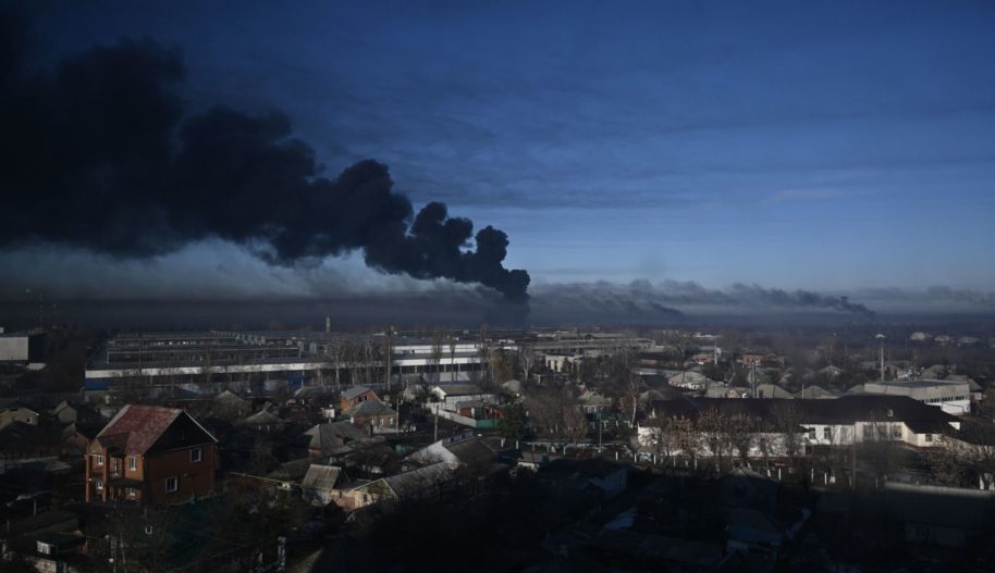 Black smoke rises from a military airport in Chuguyev near Kharkiv on February 24, 2022. Photo by ARIS MESSINIS/AFP via Getty Images