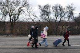 An Ukrainian family walks towards the Medyka-Shehyni border crossing between Ukraine and Poland as they flee the conflict in their country, near the Ukrainian village of Tvirzha, some 20km from the border, on February 28, 2022. Photo by DANIEL LEAL/AFP via Getty Images