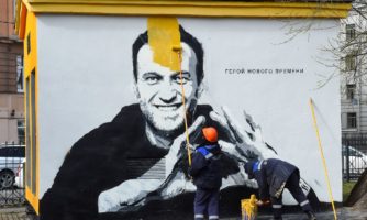 A worker paints over graffiti of jailed Kremlin critic Alexei Navalny in Saint Petersburg on April 28, 2021. (Photo by OLGA MALTSEVA/AFP via Getty Images