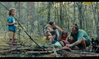 Kadr z filmu przedstawiający rodzinę w lesie.